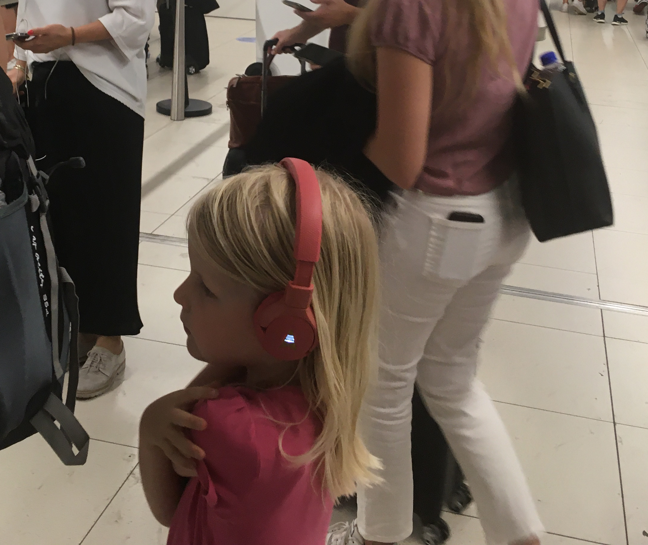 Girl at the airport with POGS The Gecko